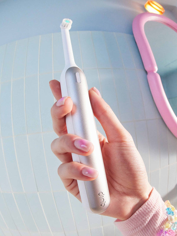 A model holds quip 360 oscillating toothbrush