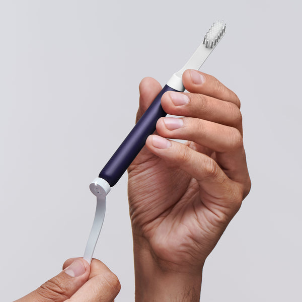 a model connecting the quip smart rechargeable sonic toothbrush to the magnetic charging cable