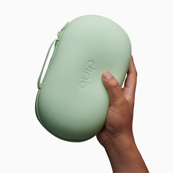 a hand model holds the green quip refresh bag, featuring the quip logo embossed on the front